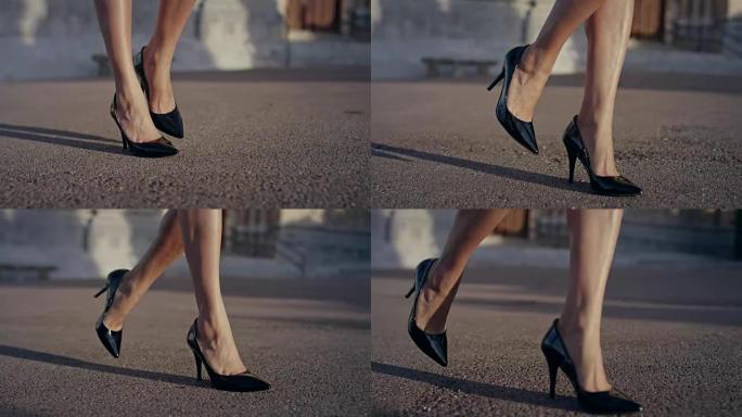 穿着高跟鞋在城市里散步的女商人。腿部特写