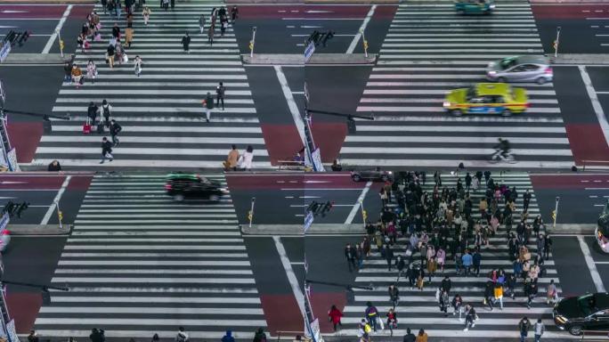 在日本新宿东京市，夜间，人群不确定的人在街上与汽车交通交叉路口行走的4k时间流逝。日本文化与购物霓虹