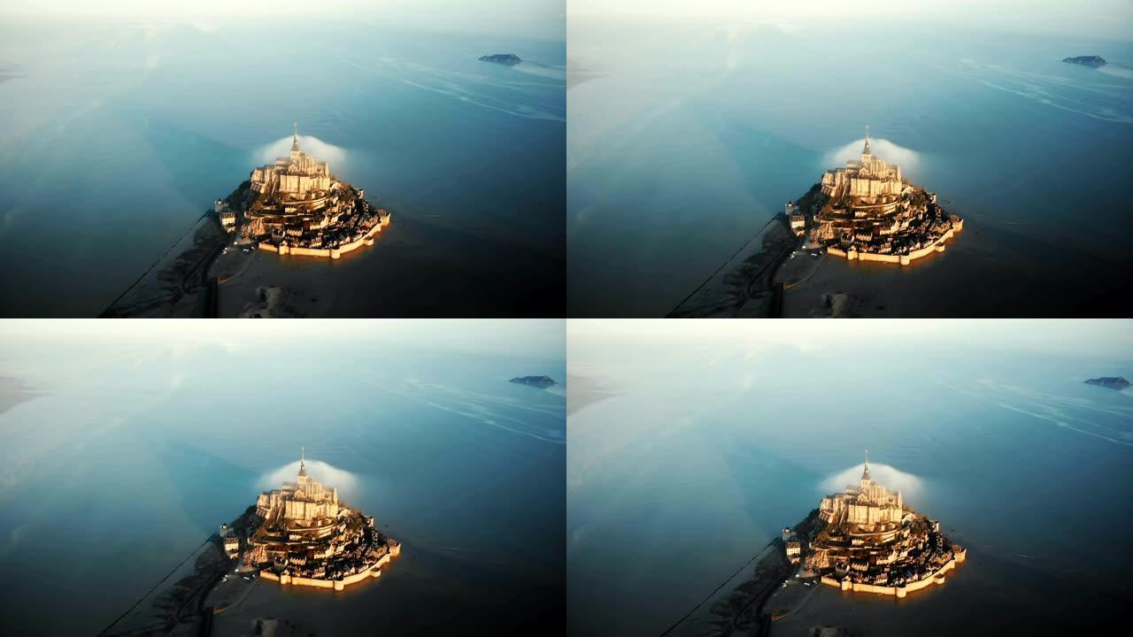 无人驾驶飞机在诺曼底海潮环绕的虚幻城堡岛上雄伟的日出圣米歇尔山上空飞得很高