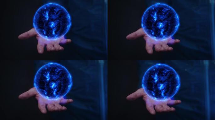 手中的太阳能。魔法球蓝色能量球手中魔法