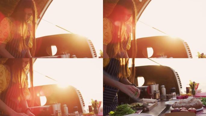 年轻女子在外面用餐车做饭