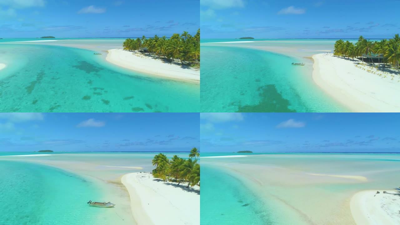 无人机: 在郁郁葱葱的热带岛屿周围的绿松石海水上方飞行。