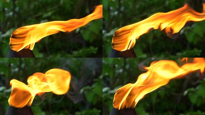 特写，dop: 夏日的微风将火炬上燃烧的火焰吹向侧面。