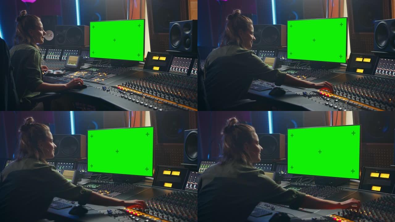 在音乐唱片公司工作的时尚女性音频工程师/制作人的肖像，使用绿屏计算机显示屏，调音台，控制台来创作新歌