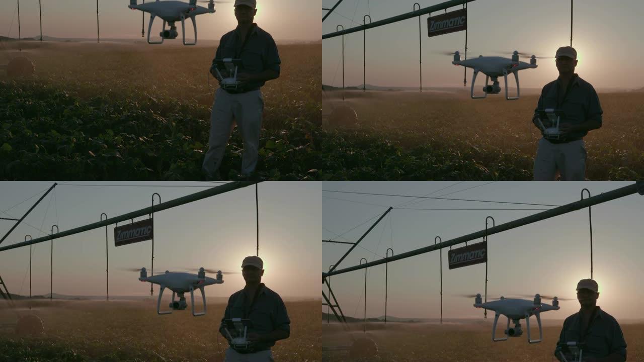 4k背光倾斜视图，现代农民使用无人机在大型蔬菜农场中使用先进技术监视他的蔬菜作物，背景为中心枢轴