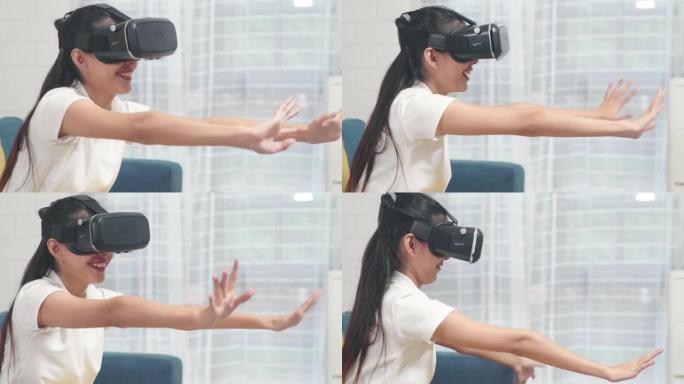 亚洲青少年妇女使用眼镜虚拟现实模拟器在客厅玩电子游戏，女性感到快乐使用放松时间躺在家里的沙发上。生活