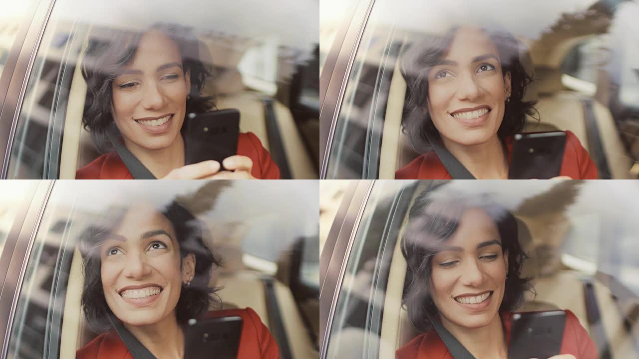美丽的女人坐在汽车上，坐在乘客座位上，使用智能手机，输入消息，通过互联网浏览。从车外拍摄的摄像机。
