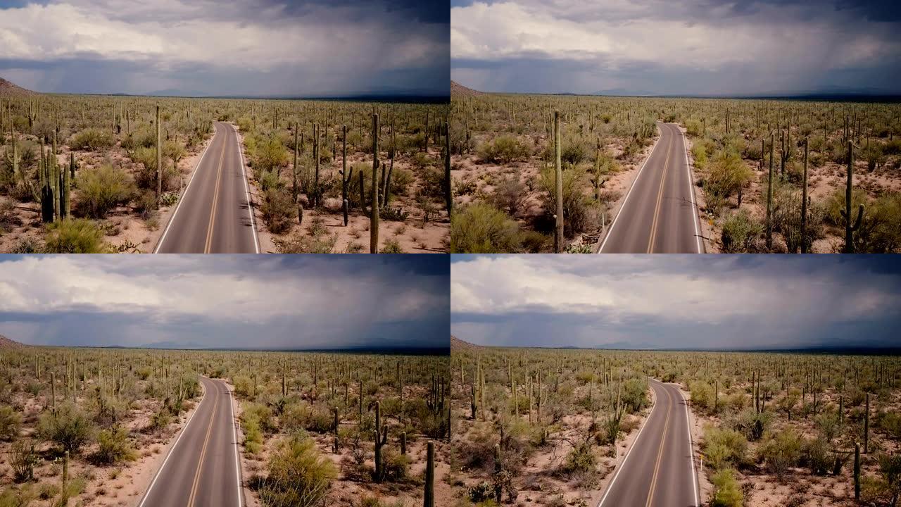 无人机在亚利桑那州国家公园暴风雨般的沙漠中，在美丽空旷的沙漠道路上飞行。
