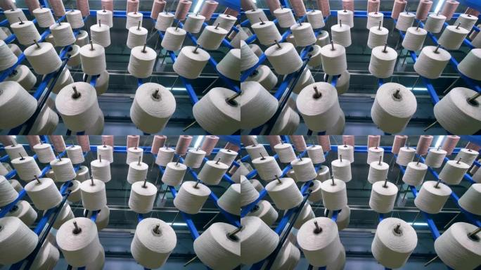 工厂设备旋转防滑钉，将光纤缠绕在其上。工业用纺织品生产线