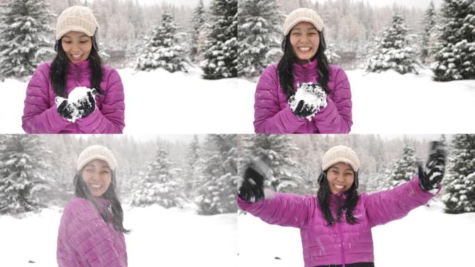亚洲女子将雪球扔进相机