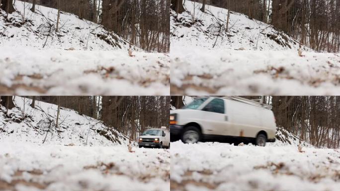 4k路边建立了一辆白色货车沿着雪道行驶的镜头。