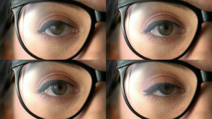 4k年轻女子用绿眼睛看着相机: 特写。