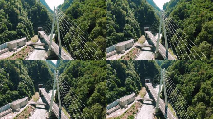 空中4k视图。河上的吊桥。在山和岩石之间飞过桥。