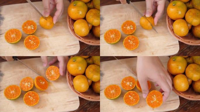 女人用手切割橙色水果以获取新鲜橙汁，慢动作