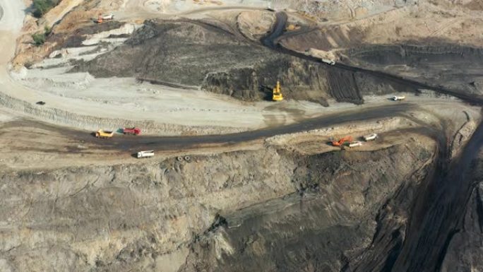 大型矿车在露天采石场中工作的矿井的一部分的鸟瞰图，在露天采石场装载推土机