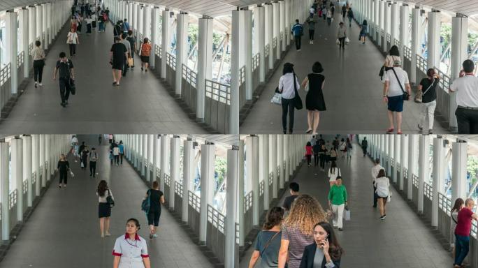 4k延时过渡在高峰时段曼谷BTS Chong Nonsi的高架地铁系统站的立交桥上拥挤的匿名人群，交