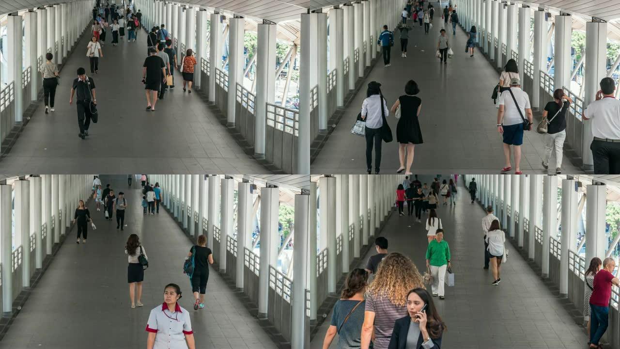 4k延时过渡在高峰时段曼谷BTS Chong Nonsi的高架地铁系统站的立交桥上拥挤的匿名人群，交