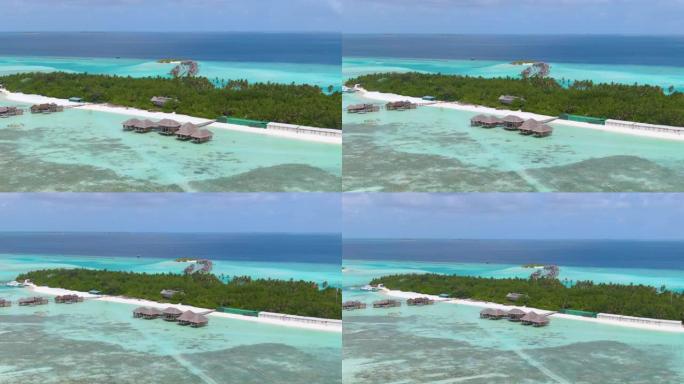 空中: 沿着马尔代夫天堂岛的空旷的白色沙滩飞行。