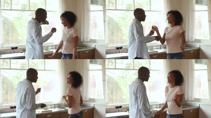 恋爱中的非洲夫妇在浪漫约会期间在厨房跳舞
