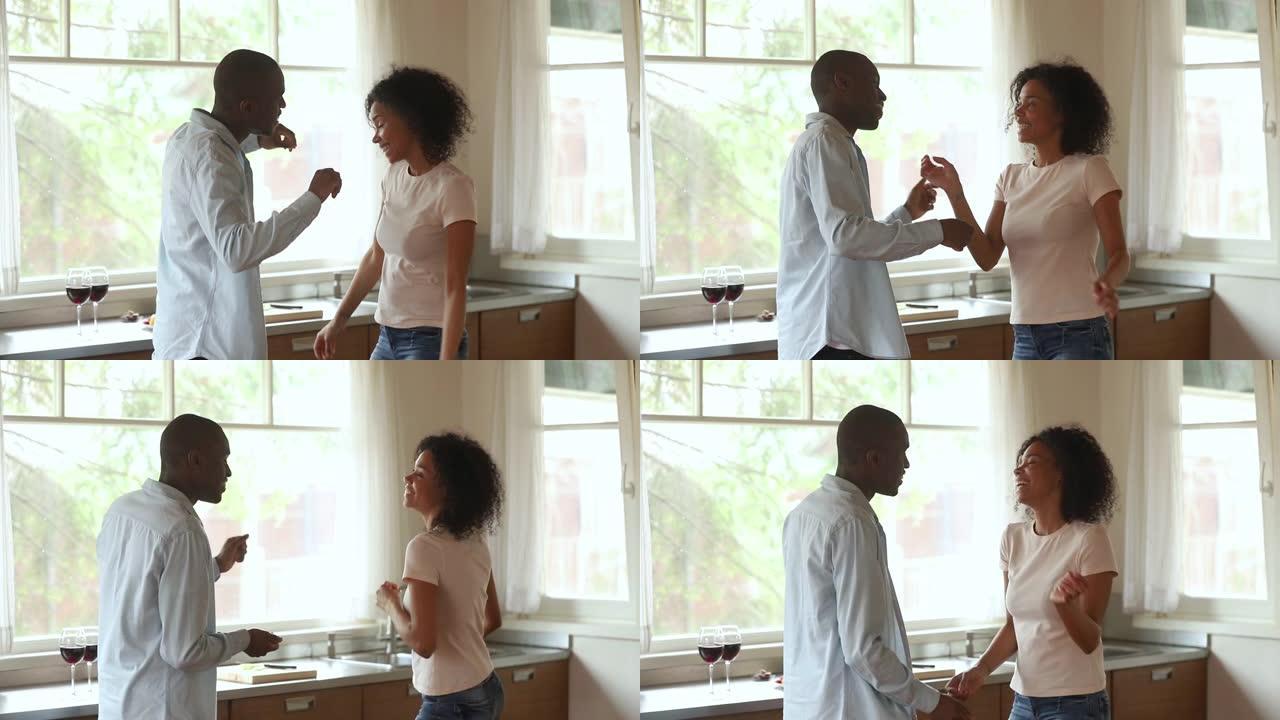 恋爱中的非洲夫妇在浪漫约会期间在厨房跳舞