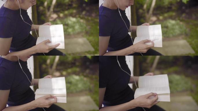 CU-女人用入耳式耳机重新阅读和阅读书籍