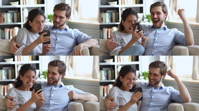 喜出望外的年轻夫妇看着智能手机获奖礼物或奖品