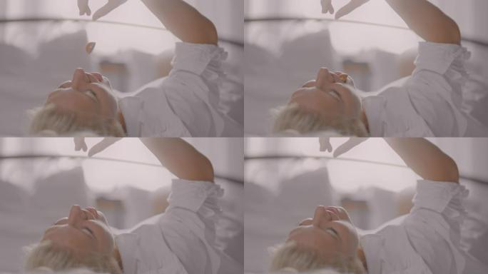 SLO MO女人躺在床上吃果仁糖