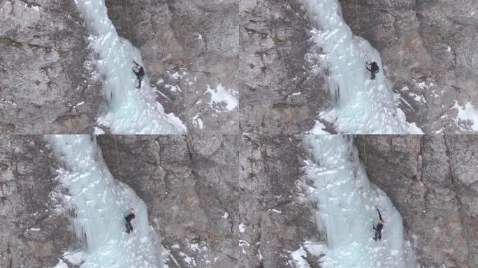 空中: 极端的攀冰者爬上美丽的冰冻瀑布。