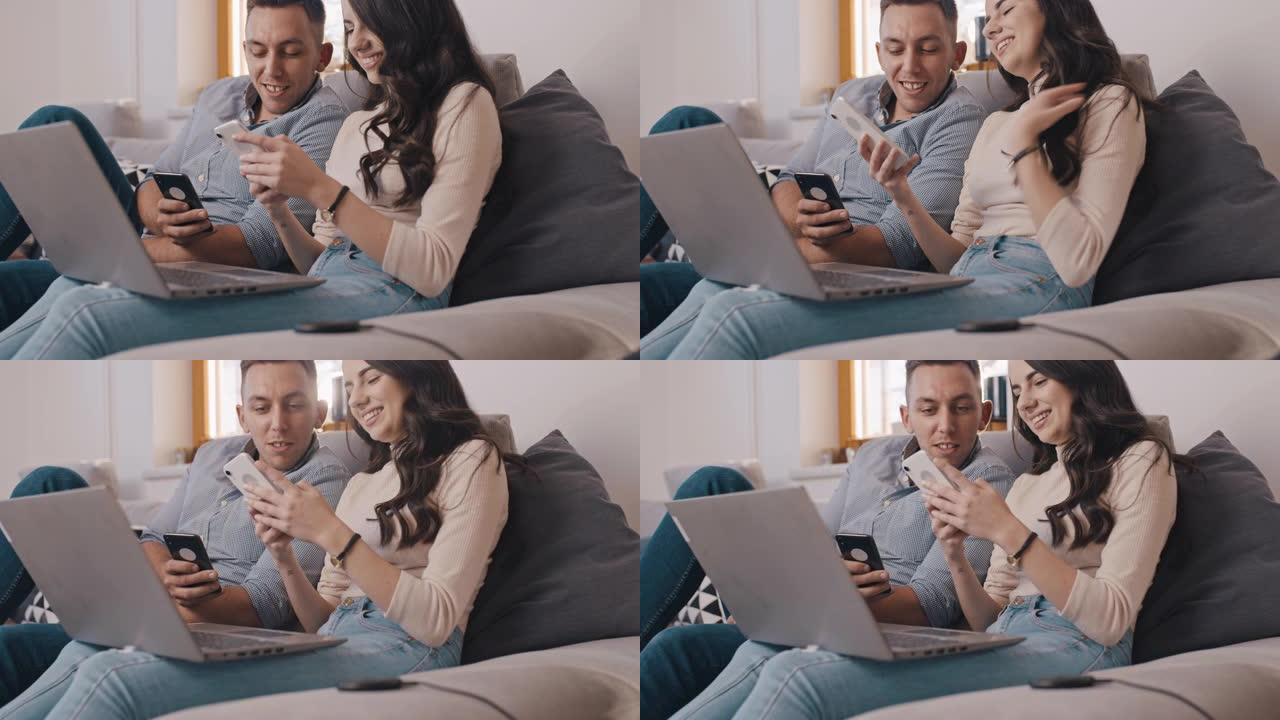DS年轻夫妇在家中使用智能手机和笔记本电脑