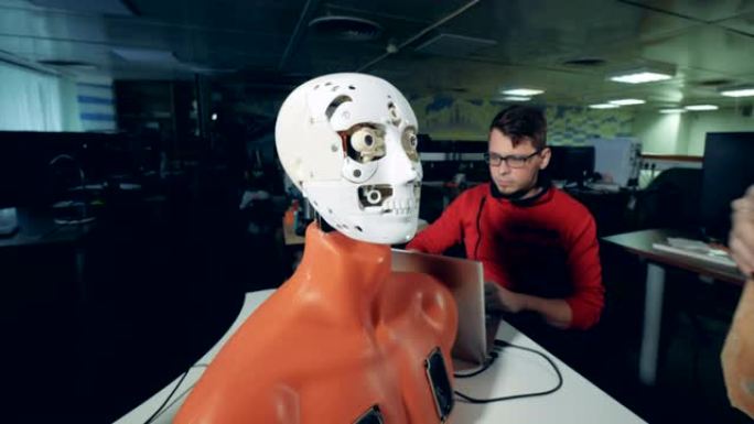 女专家正在调整机器人脸上的仿人面具