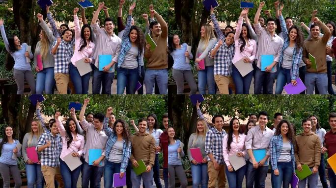 一群学生举起手来，微笑着庆祝期末考试