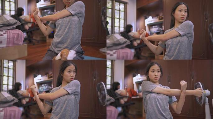 4k女人看着笔记本电脑看到在线训练在家里伸展