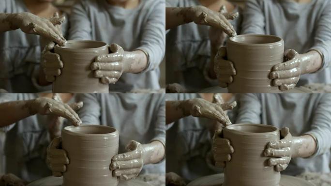 无法识别的儿童制作陶器