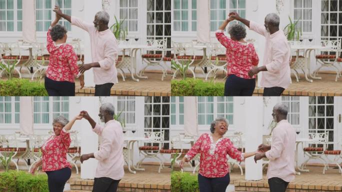 一对资深的非洲裔美国夫妇在一起度过时光，在花园里跳舞。