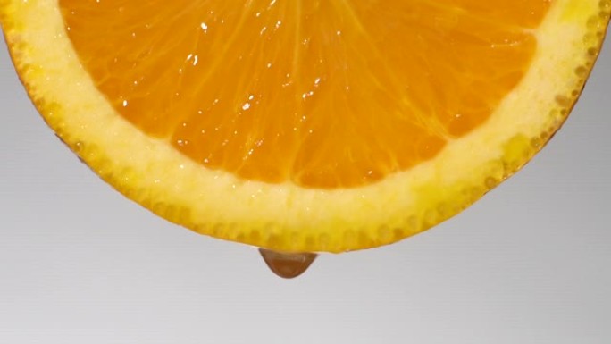 慢动作: 从橙色切片上滴一滴水