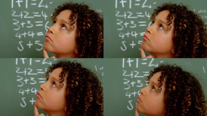 体贴的混血女学生的特写镜头，手握下巴站在学校的教室里4k