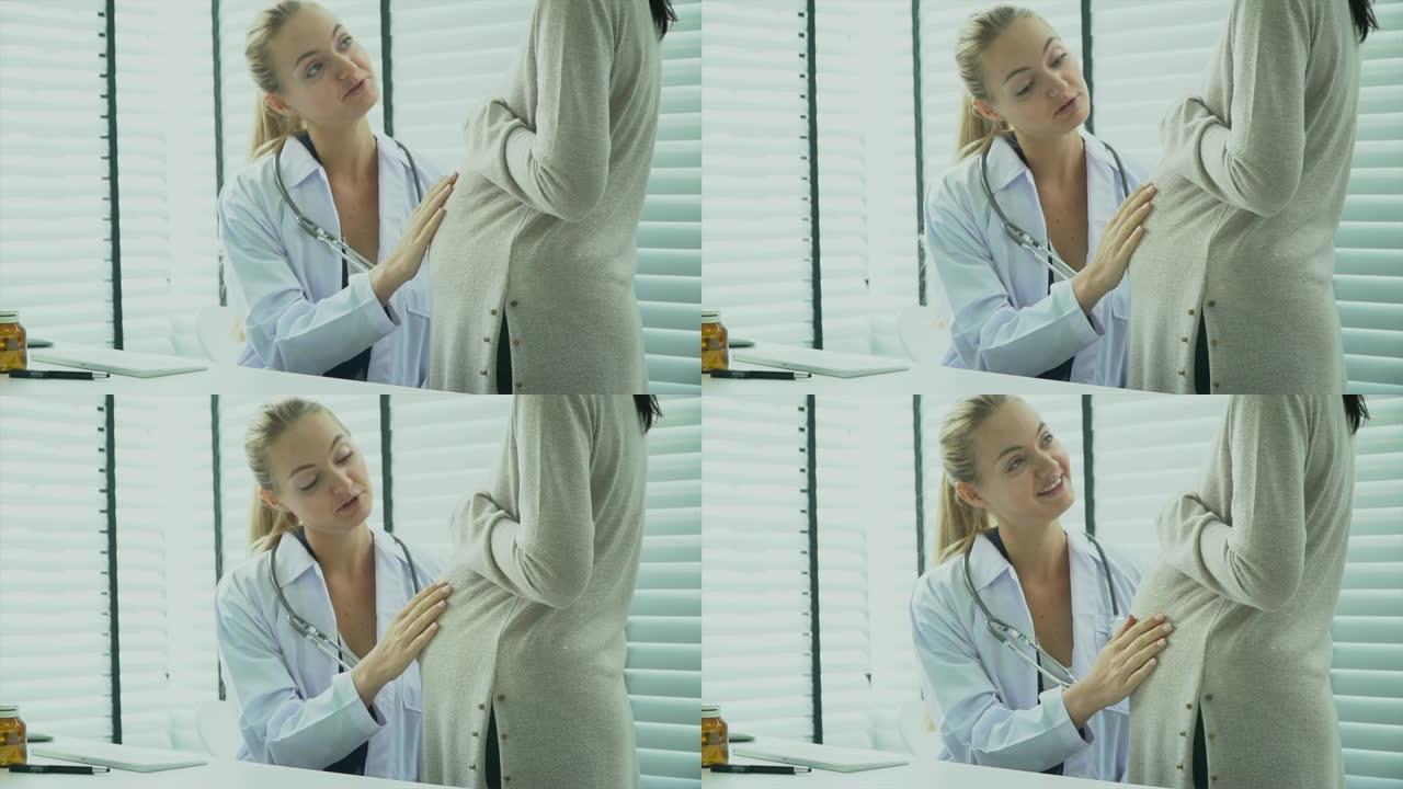 医生和孕妇孕妇孕检医生检查抚摸肚子