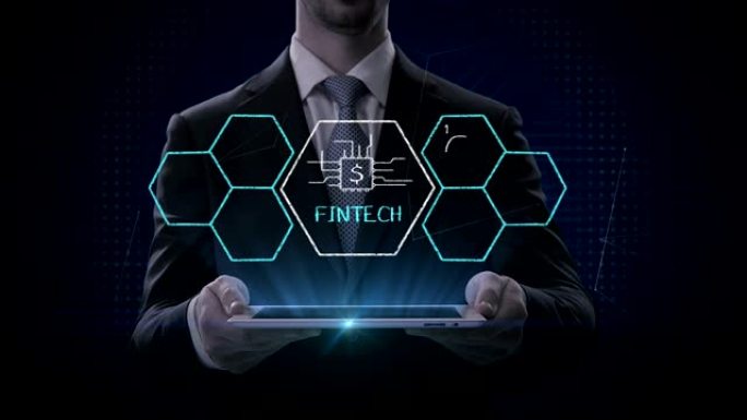 商人举起平板电脑，Fin-tech图标和各种图形。未来的金融技术。4k电影。