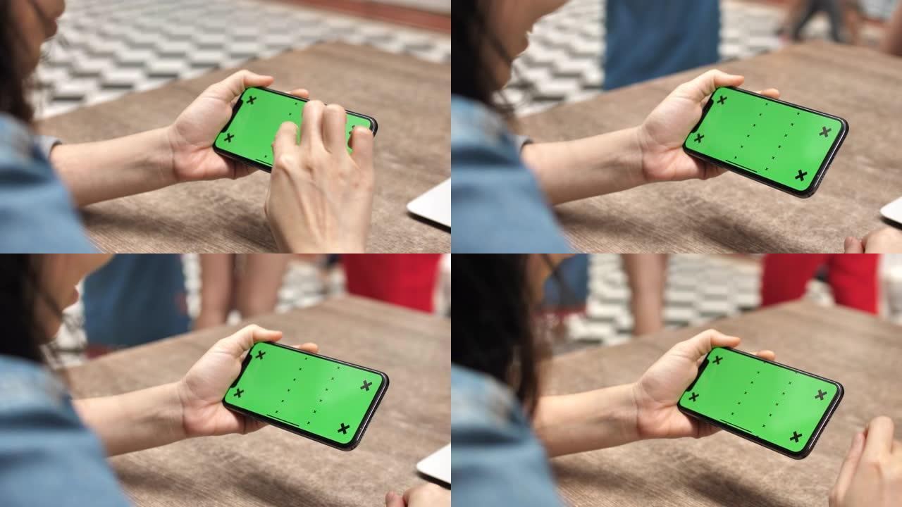 女人在水平上使用智能手机绿屏