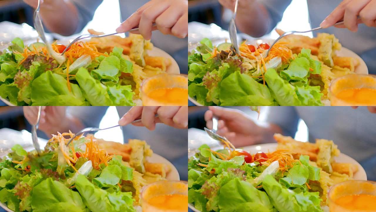 女人的手吃沙拉，健康食品