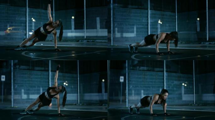 美丽的运动健身女孩做俯卧撑运动。她正在一个有围栏的室外篮球场里锻炼身体。居民区雨后的夜间录像。