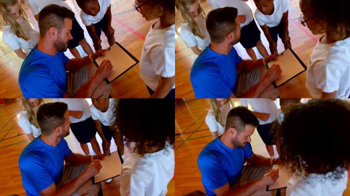 体育老师和学童在篮球场4k上讨论剪贴板