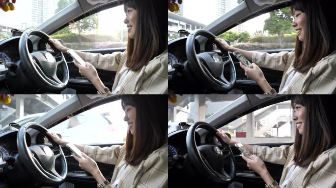 亚洲女性在城市使用智能手机和驾驶汽车
