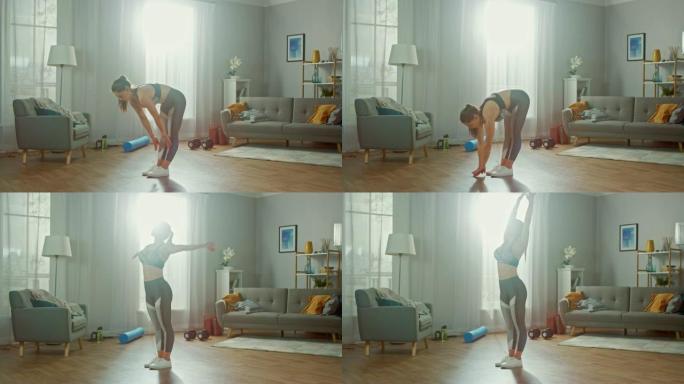 穿着运动上衣的美丽匀称的健身女孩正在她明亮宽敞的起居室里做伸展瑜伽练习，室内装饰现代。