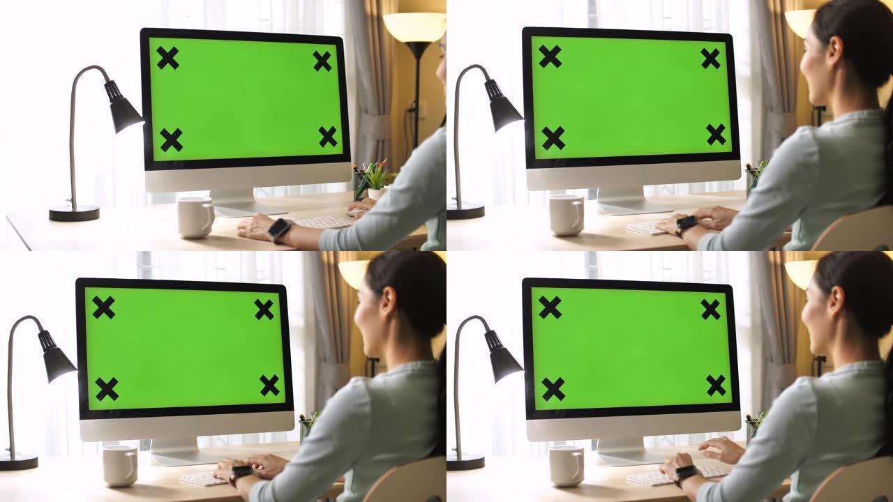 亚洲女人在家里的电脑上有绿屏，多莉开枪