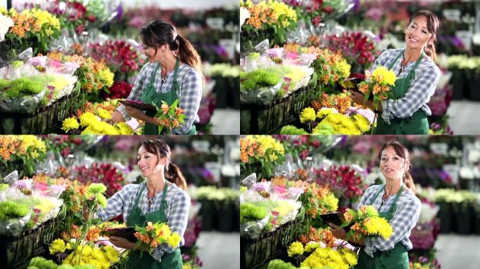 女人在花店工作，为花束采摘花朵