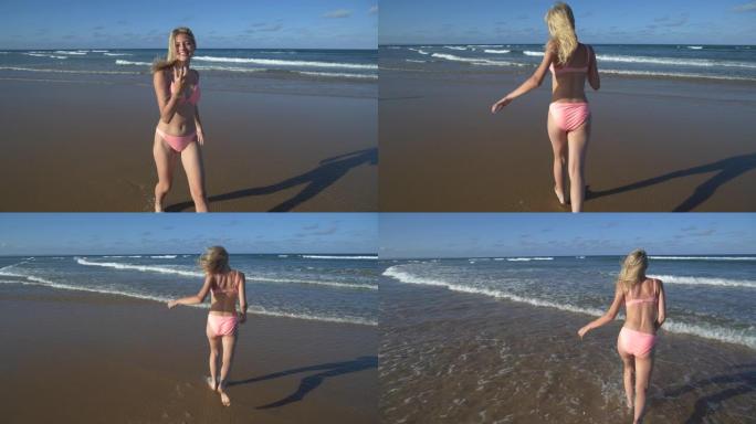 4k慢动作视图，一个美丽的年轻女子调情地呼唤某人进入海浪中寻找乐趣，转身并跑进大海，南非