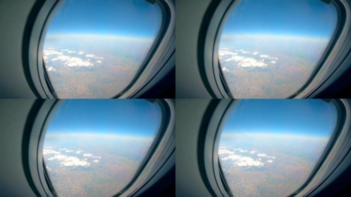 飞机舷窗，从飞机上看到土地和天空