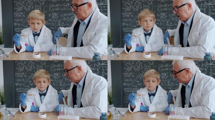 男生和老师在实验室里忙于化学测试，一起学习化学