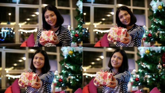 年轻女子在圣诞节期间对她的礼品盒感到非常兴奋，慢动作